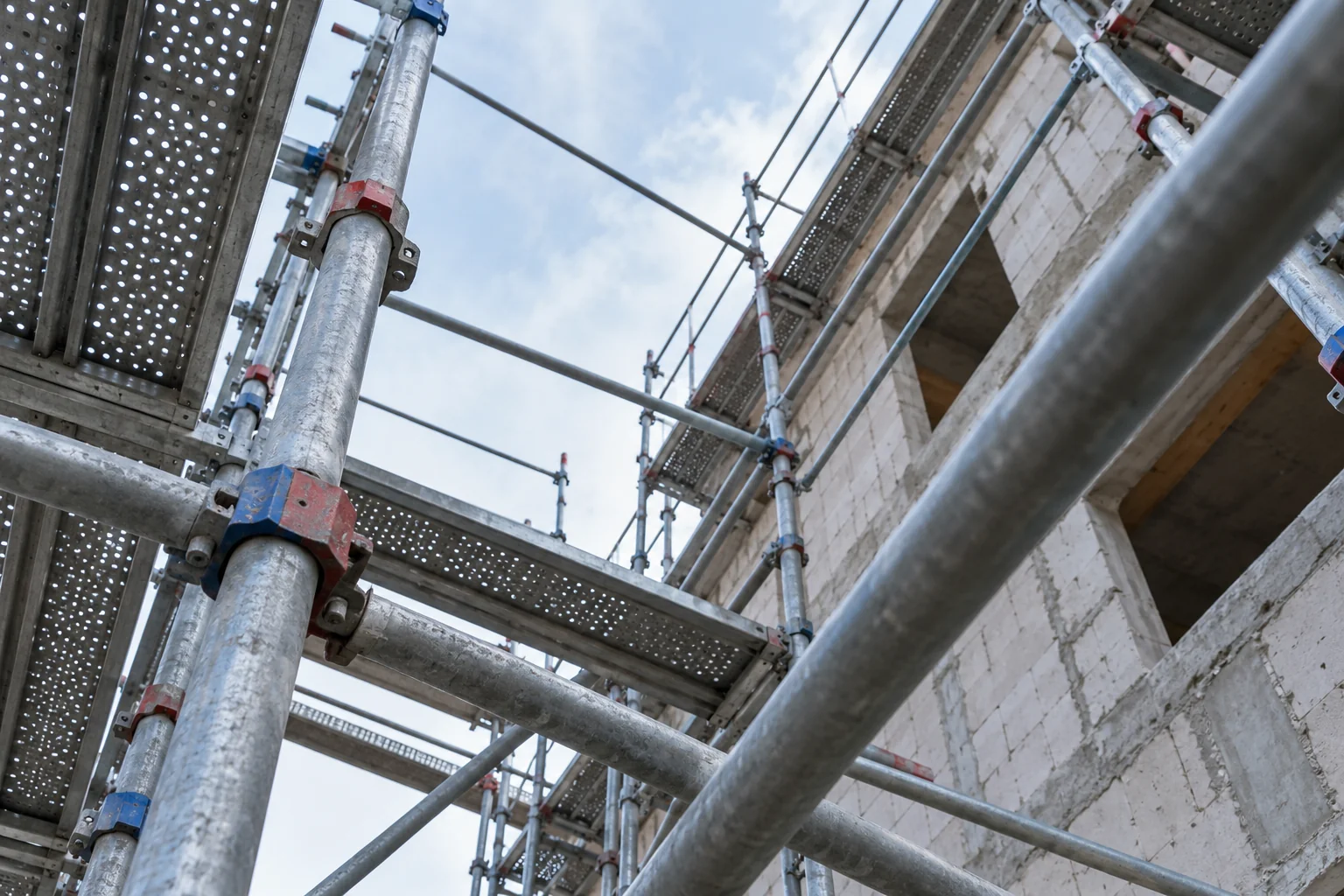 AI-generated editorial view of scaffold tubes forming a precise grid against a cool pale sky.